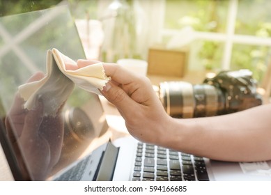 Close-up Of Man Hand Cleaning Laptop  - Powered by Shutterstock