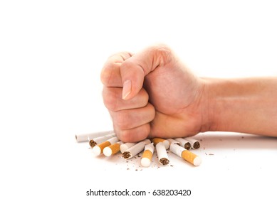 Close-up man hand crushing a pile of cigarettes isolated on white. Angry hand breaking tobacco. Gesture for anti, quit smoking addiction concept. Stop smoking message, social issue concept background.