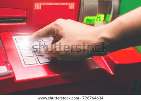 Close-up of man hand  entering PIN/pass code on ATM/bank machine keypad