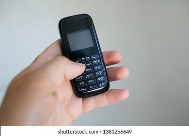 Close-up Of Man Hand Holding Old Black Mobile Phone