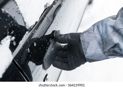 Closeup Of Man Hand Opening Frozen Car Door In Winter