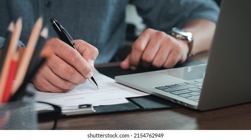 Close-up of man hand using writing pen memo on notebook paper or letter, diary on table desk office. Workplace for student, writer with copy space. business working and learning education concept.