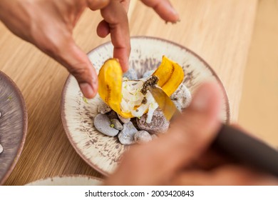 Closeup Of Man Hands Cooking Banana Chifles With Fake Squid Noodles And Beluga Caviar