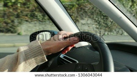 Close-up of man hands holding steering wheel and driving on commute