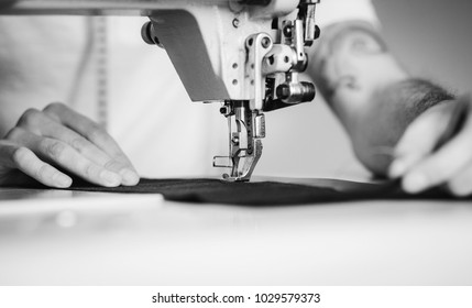 Close-up Man Hands Sewing Fabric On Sewing Machine