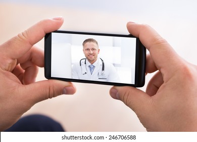 Close-up Of Man Having Video Chat With Doctor On Smartphone