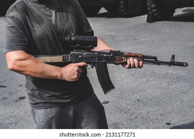 Close-up Of A Man Holding An Assault Rifle With A Sniper Scope