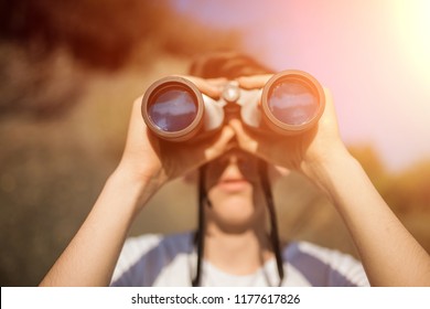 Close-up of a man holding hand. looking. using binoculars with copyspace, technology Binoculars background concept