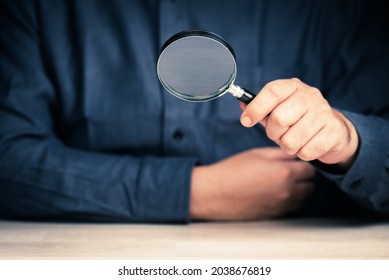 Closeup man holding a magnifying glass, searching tool, analysis,  and scrutiny concept - Shutterstock ID 2038676819