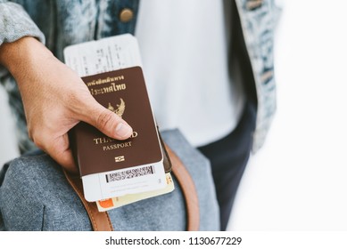 Closeup of man holding passports and boarding pass concept for travel vacation time. - Shutterstock ID 1130677229