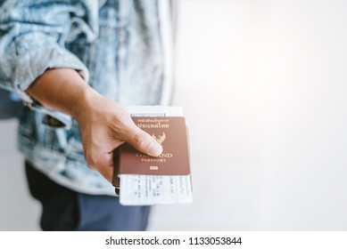 Closeup of man holding passports and boarding pass concept for travel vacation time. - Shutterstock ID 1133053844
