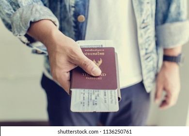 Closeup of Man holding passports and boarding pass,Business travel concept - Shutterstock ID 1136250761