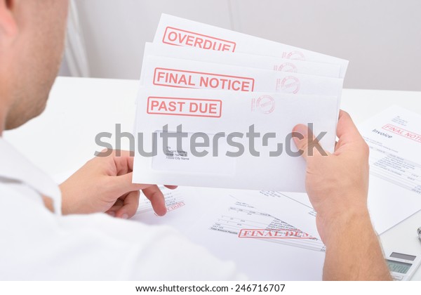 closeup-man-holding-statements-pending-dues-stock-photo-246716707