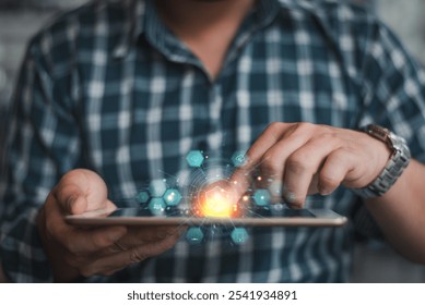 Close-up of a man interacting with a tablet, featuring glowing holographic digital icons and technology interface overlays.   - Powered by Shutterstock