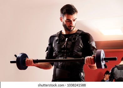 Closeup Of Man Lifting Weights In Gym, Using EMS Stimulation 