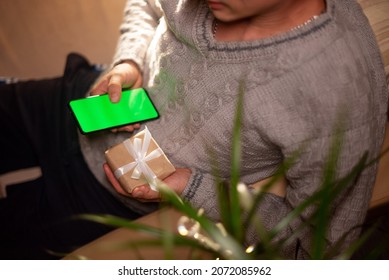 close-up A man orders a gift in an online store using a smartphone for his family and his beloved woman for Christmas and New Year. online shopping concept. chroma key. - Powered by Shutterstock