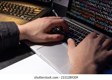 Close-up of man planning hacker attack. Man using laptop, typing code. Male hands on keyboard. Hacking, technology, cybercrime concept