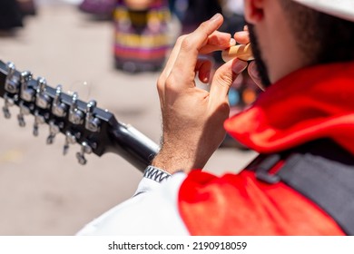 Close-up Of A Man Playing A Bamboo Flute Outdoors. Colombian Folk Music. Man In Typical Colombian Costume.