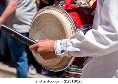 Close-up Of A Man Playing A Bass Drum In A Cultural Parade. Hands Of A Man Playing A Traditional Musical Instrument Of Colombian Culture.