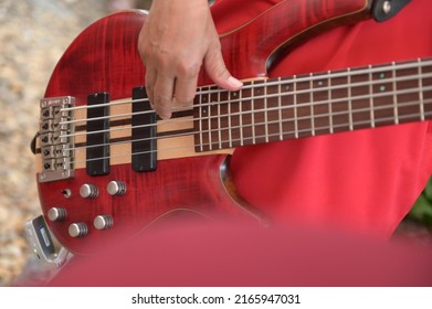 Close-up Of A Man Playing A Red Guitar Stock Picture