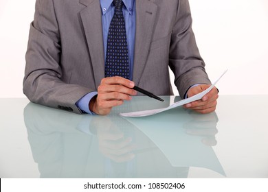 Close-up Of Man Proof Reading A Document