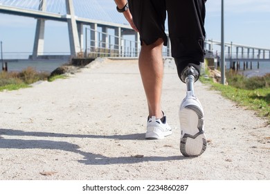 Close-up of man with prosthetic leg walking. Sportsman in blue shorts and white sneakers photographed during training. Sport, disability, hobby concept - Powered by Shutterstock