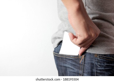 Closeup Man Pulling A Card On His Back Pocket, Blank Card With Copy Space In A Pocket Of Jeans.