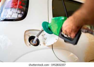 Closeup Of Man Pumping Ethanol Fuel In Car At Gas Station In Brazil.