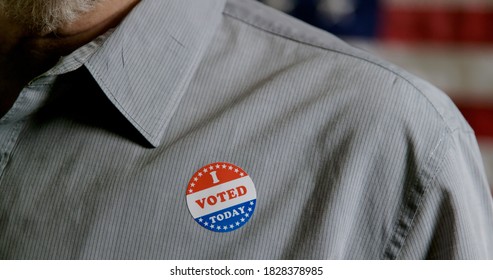 Closeup Of Man Putting A I Voted Sticker On His Shirt