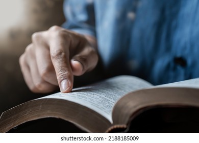 Close-up of a man reading the Bible Spiritual concepts by studying the Holy Scriptures together. - Shutterstock ID 2188185009