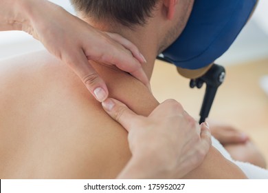 Closeup Of Man Receiving Shoulder Massage By Therapist In Hospital