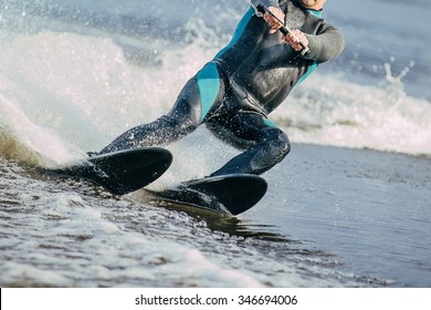 Closeup Man Riding Water Skis On Lake In Summer. Body Parts Without A Face