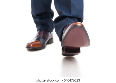 Close-up Of Man Shoes And Trousers In Walking Position Isolated On White Background