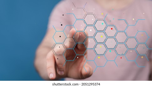 A closeup of a man tapping on a 3d illustration of a hexagonal hologram screen - futuristic technology concept