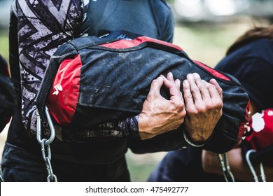 Close-up Of Man Training With Sandbag