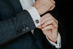 Close-up Of A Man In A Tux Fixing His Cufflink.