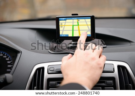 Close-up Of Man Using Gps Navigation System In Car