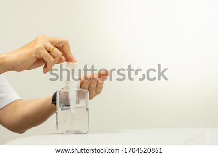 Closeup man using hand press bottle alcohal gel for cleansing, remove and kill bacteria, germ and virus. using for heathcare and sanitary concept with copy space text.