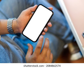 Close-up, A Man Using His Smart Mobile Phone, Sitting At His Desk. Phone Blank Screen For Your Banner Mockup.