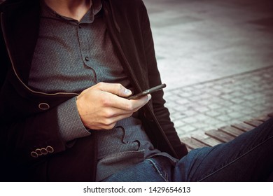 closeup of man using mobile phone, copy space available on the right