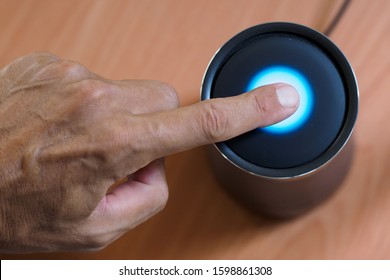 Close-up. Man using smart speaker, with voice control. top view.