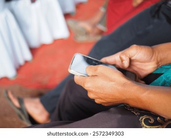 Closeup of a man using a smartphone to scroll social media