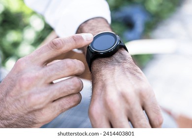 Close-up of man using smartwatch outdoors - Powered by Shutterstock