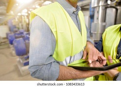 Closeup of man using tablet on industrial site