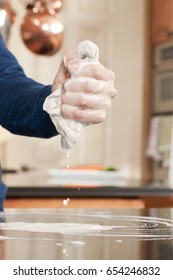 Closeup Of A Man Washing Or Cleaning A Black Granite Countertop 