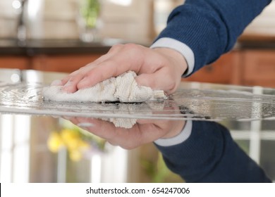 Closeup Of A Man Washing Or Cleaning A Black Granite Countertop 