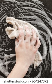 Closeup Of A Man Washing Or Cleaning A Black Granite Countertop 