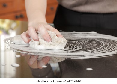 Closeup Of A Man Washing Or Cleaning A Black Granite Countertop 