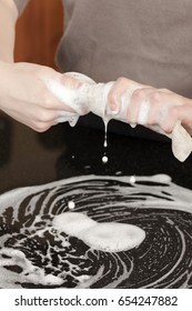 Closeup Of A Man Washing Or Cleaning A Black Granite Countertop 