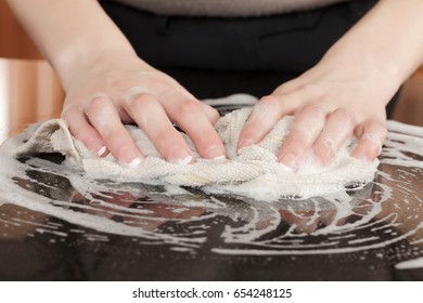 Closeup Of A Man Washing Or Cleaning A Black Granite Countertop 